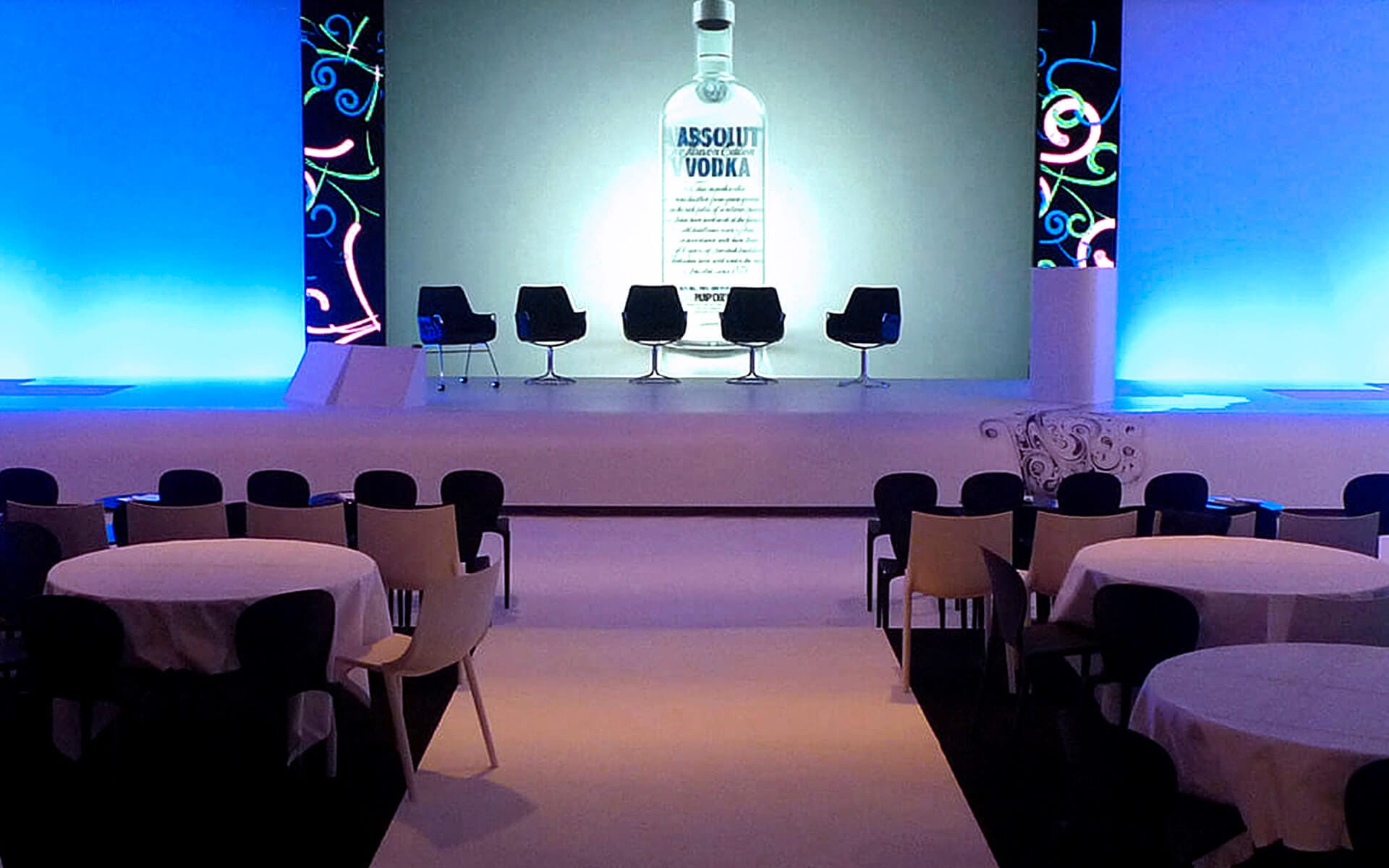 White conference stage with LED screens and rear projection for The Absolut Company