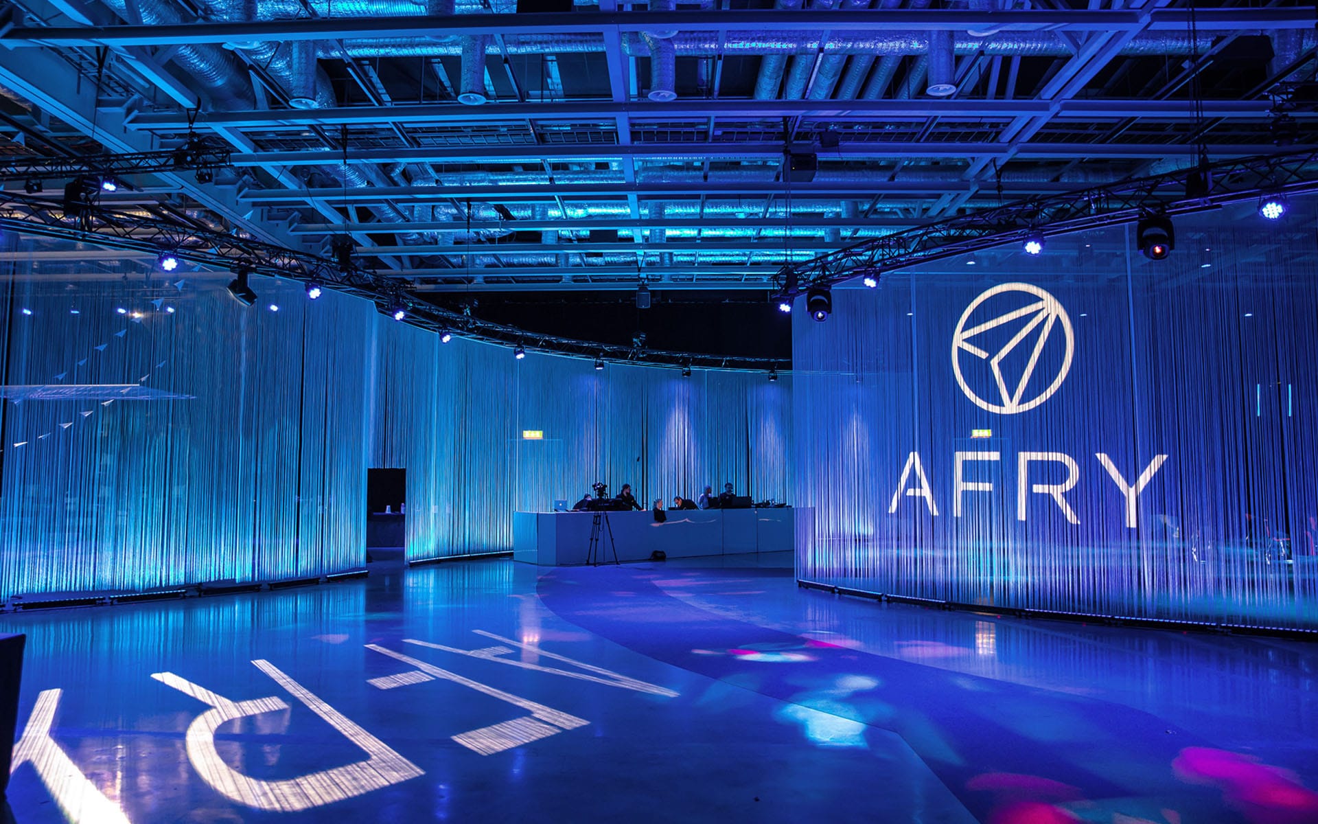 AFRY Leadership Summit – entrance lighting with illuminated wire curtains suspended from circular truss at Strawberry Fields, produced by EDGE's lighting department.