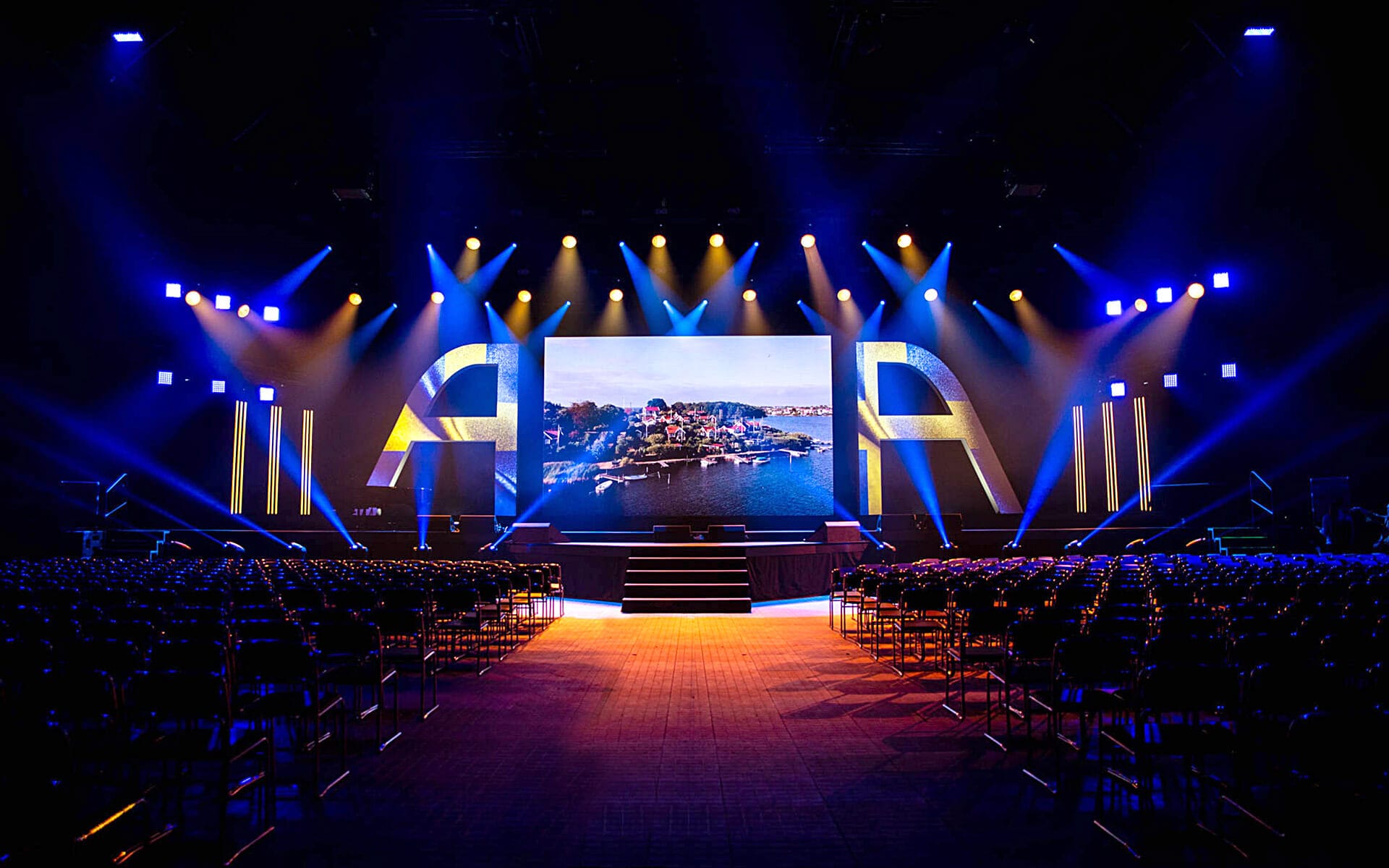 Front view of ATEA stage with Swedish colours in lighting, Vinnarhallen Boson 2023