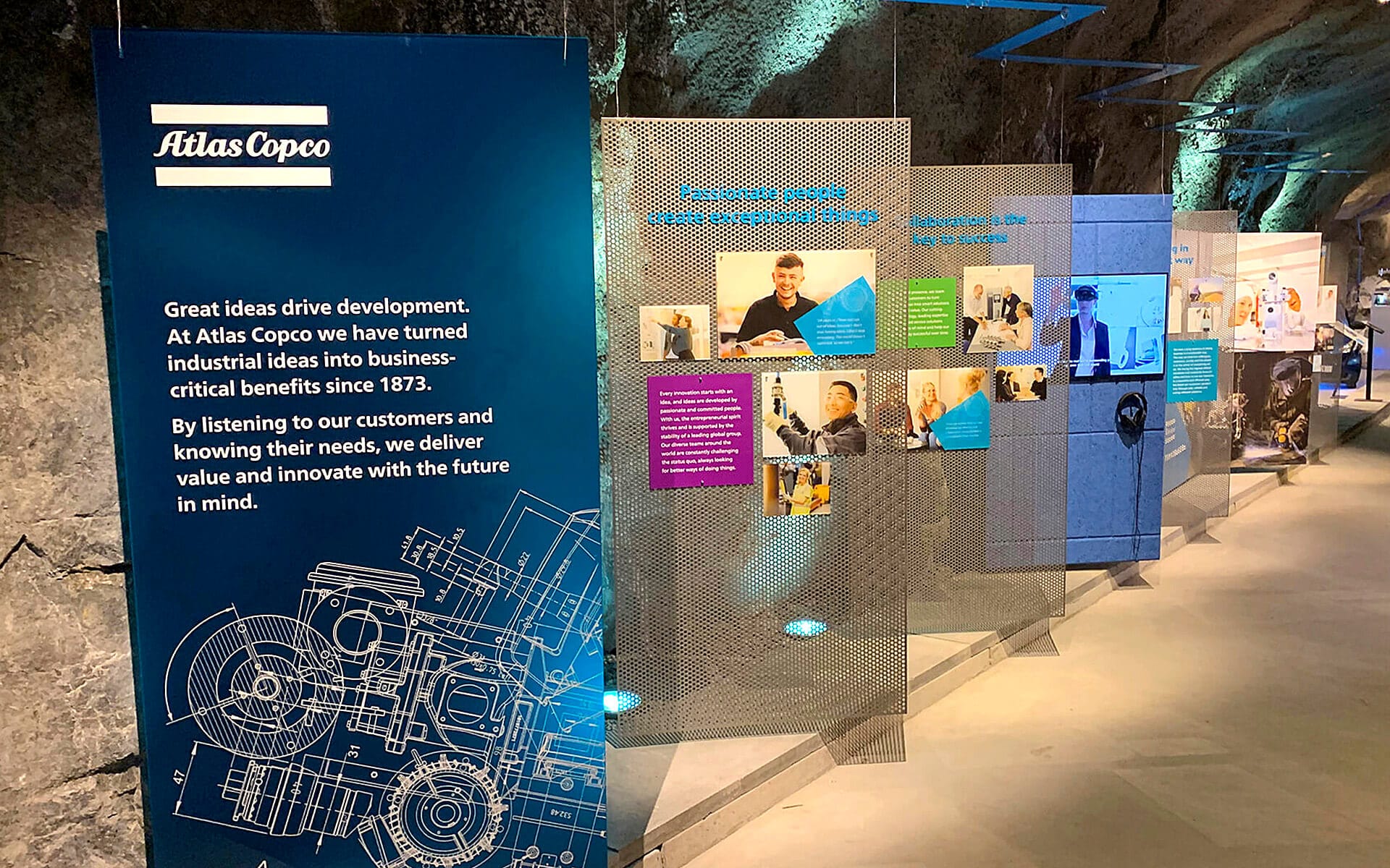 Left side of mine passage with illuminated metal display signs, Atlas Copco exhibition Sickla