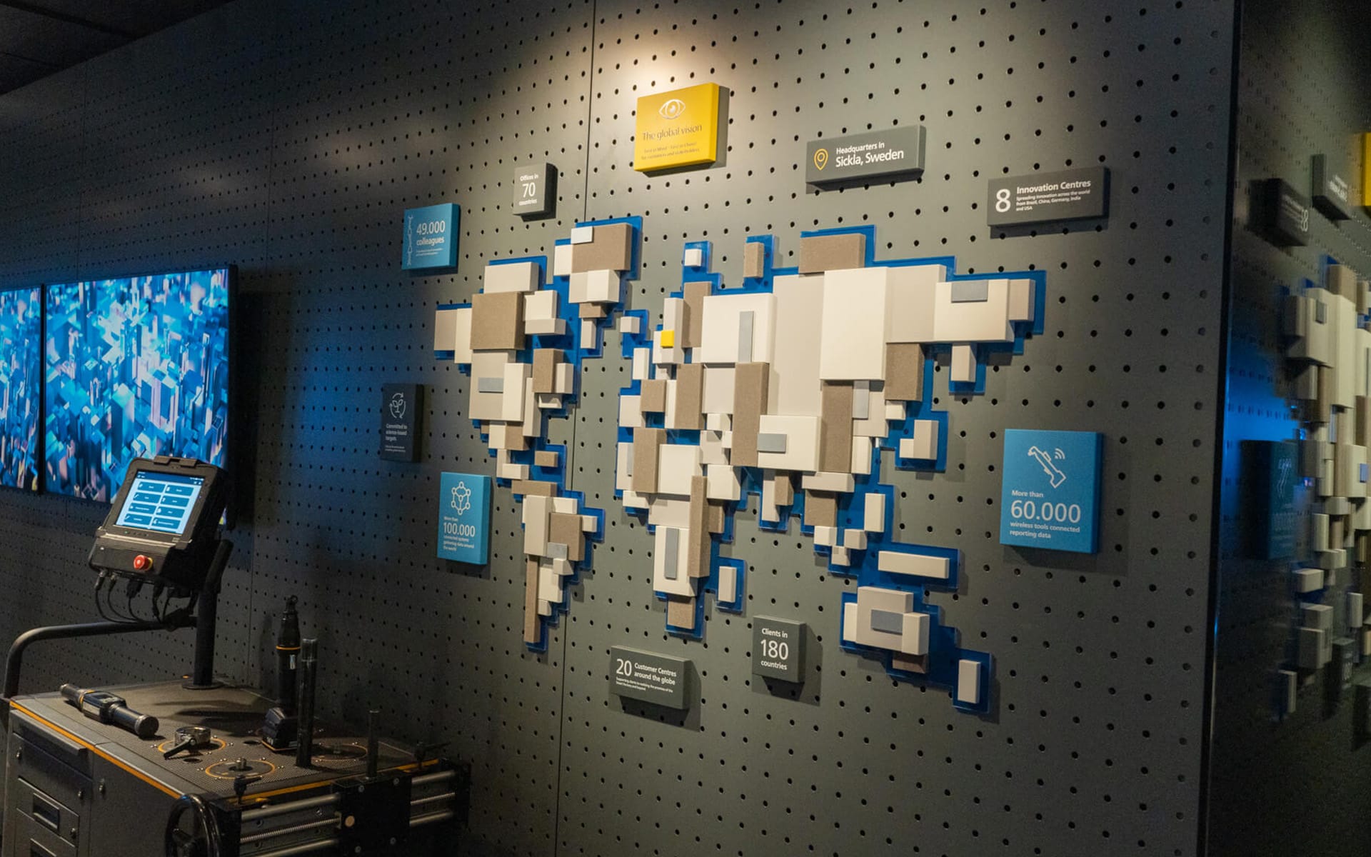 Atlas Copco showroom in Sickla – a CNC-milled world map produced by EDGE's carpentry workshop with integrated lighting showing Atlas Copco's global presence.