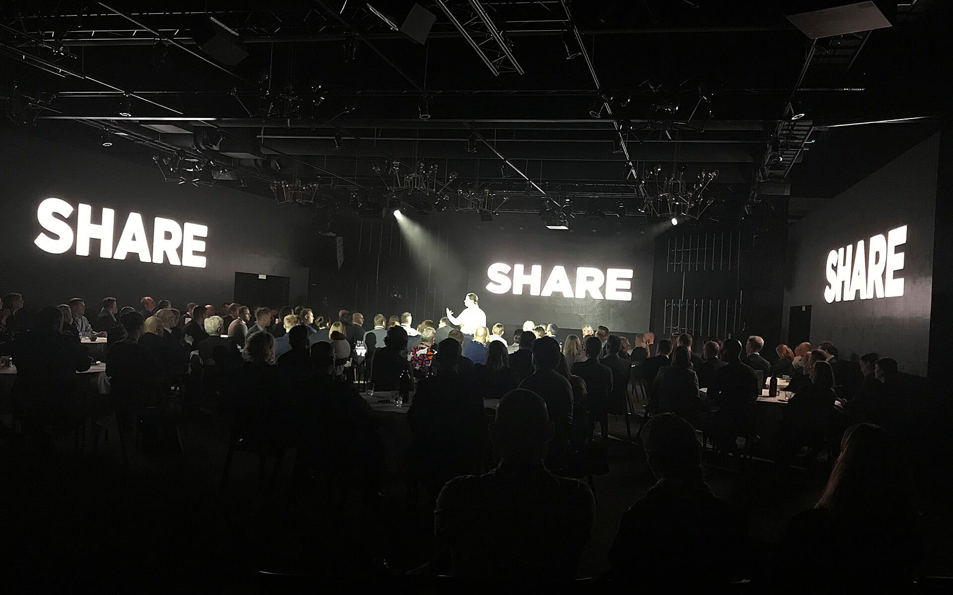 Presenter surrounded by three LED screens in Grand Hall, Coor management meeting Steam Hotel