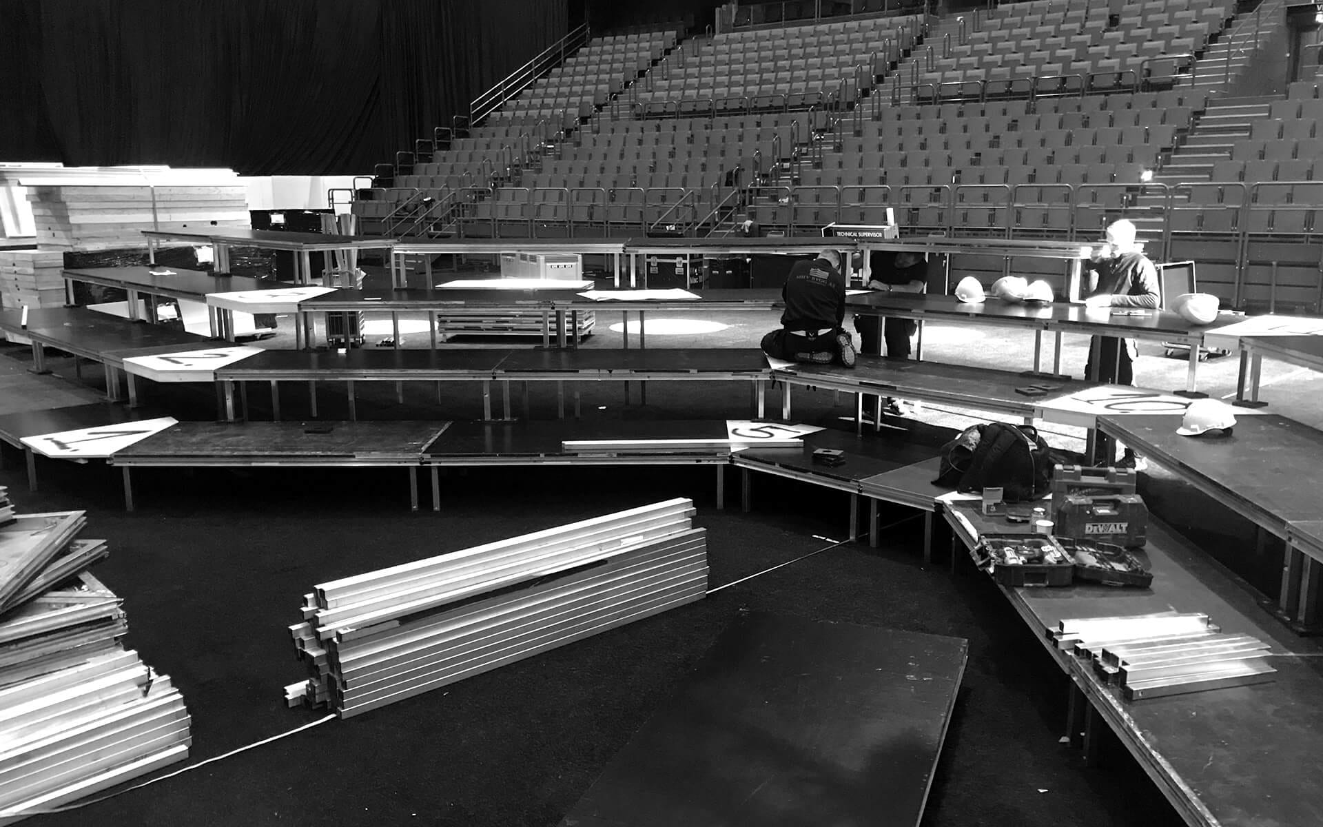 Stage podiums being assembled ahead of Dustin Expo at Avicii Arena – systematic installation for a stable and safe stage.