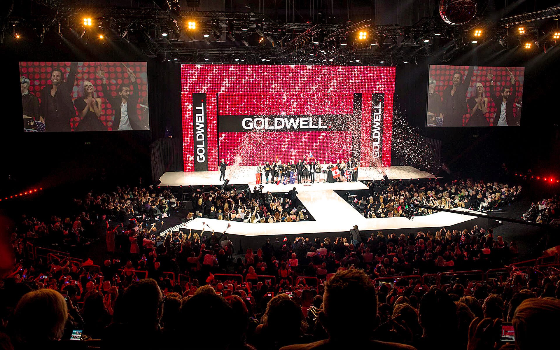 Goldwell Global Zoom 2016 at Avicii Arena – a double-sided runway stage with a fashion show on one side and a nightclub environment on the other.