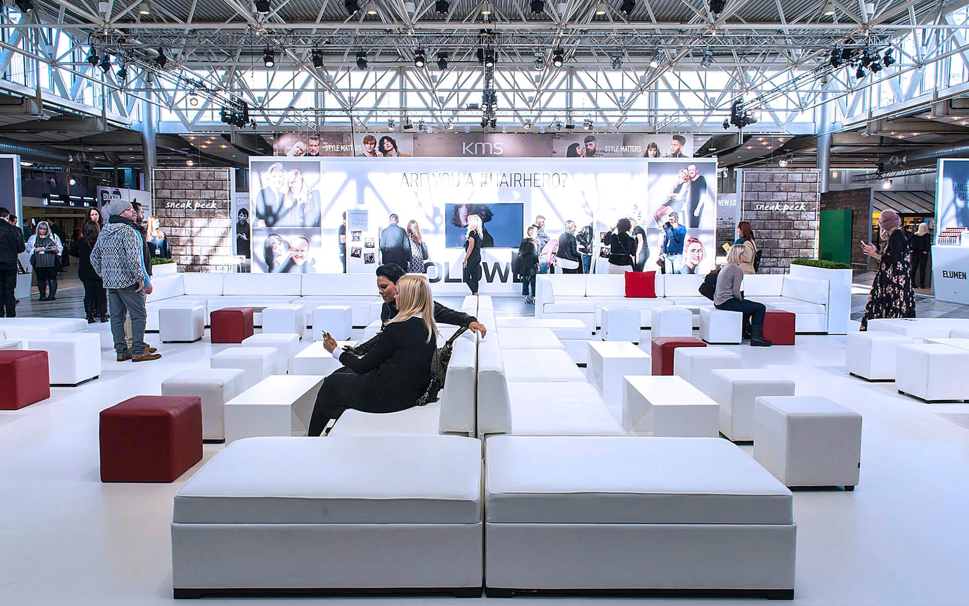 Large white lounge in foyer at Stockholmsmässan with in-house sofa series, Goldwell Global Zoom 2016