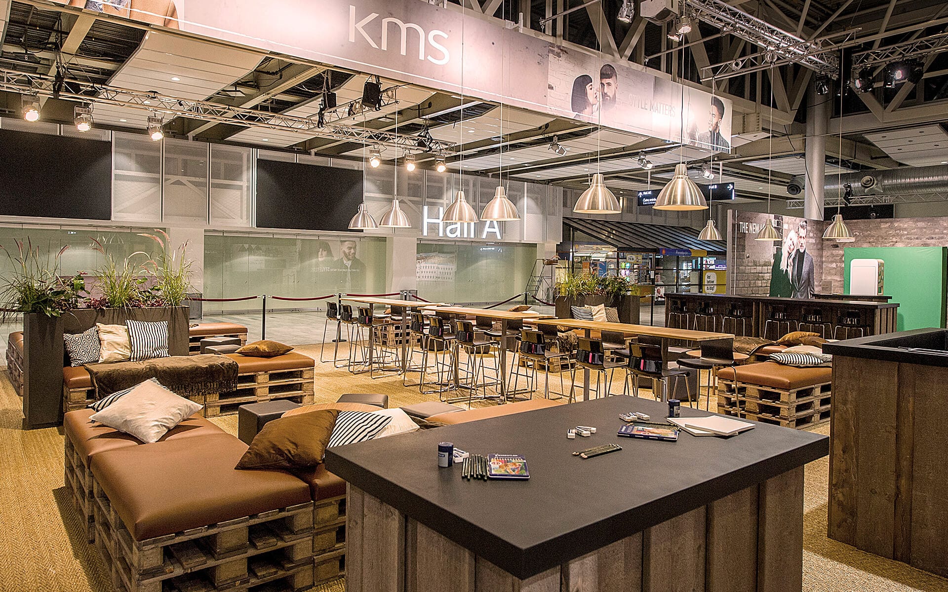 Rustic lounge with pallet sofas and leather cushions at Stockholmsmässan, Goldwell Global Zoom 2016