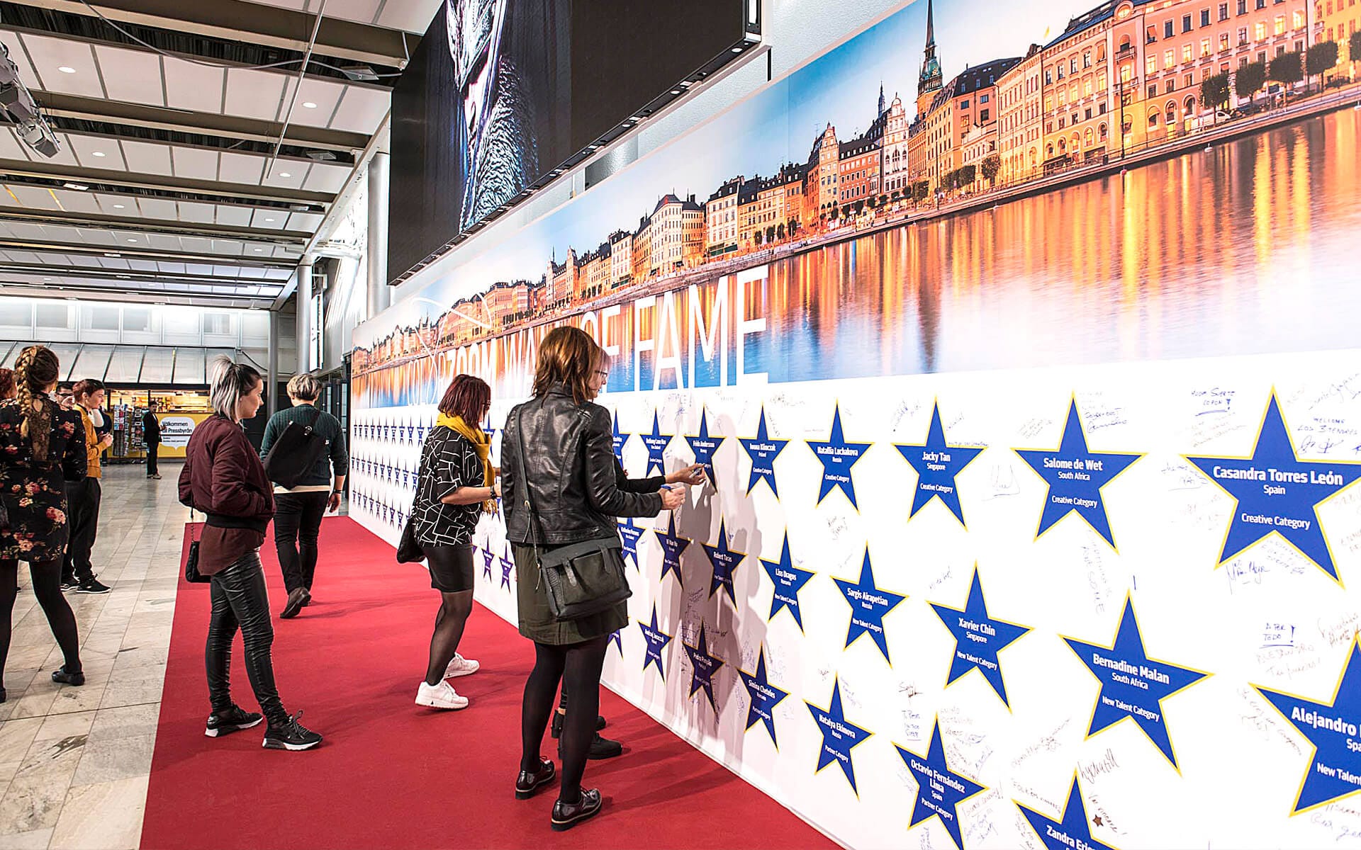 Large vinyl-wrapped Wall of Fame display at Stockholmsmässan entrance, Goldwell Global Zoom 2016