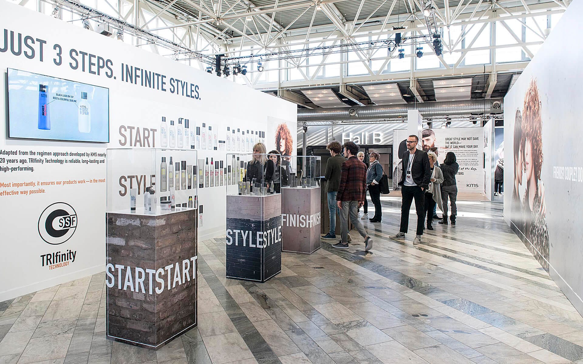 Exhibition area with vinyl-wrapped display walls and display podiums with plexiglass covers, Goldwell Stockholmsmässan