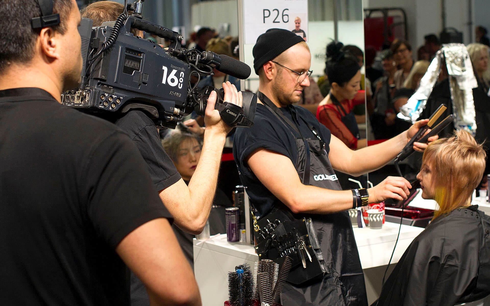 Competing hairstylist at Goldwell Global Zoom in Barcelona – lighting and competition layout designed by EDGE for optimal exposure of the stylist's work.