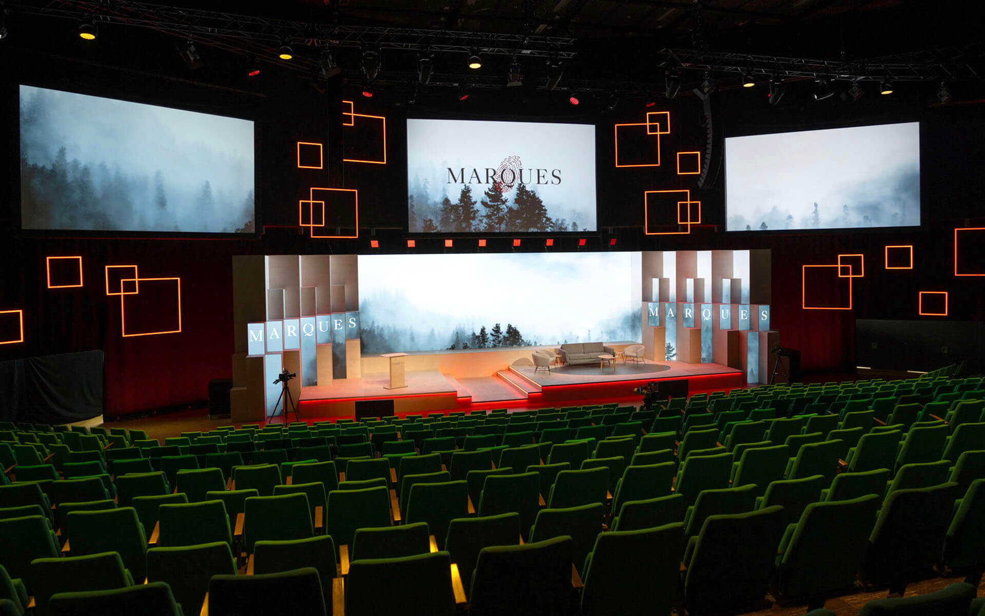 Speaker on stage with built-in light strips in the plywood pillars