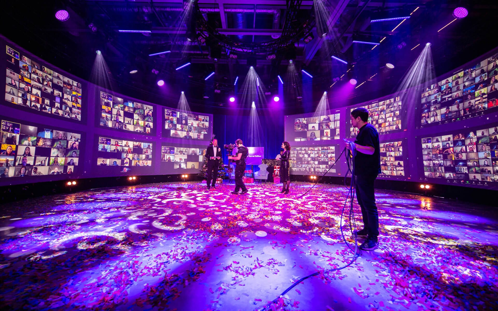 Rear-projected walls with live feed of Zoom participants in circular studio, Oriflame Strawberry Fields