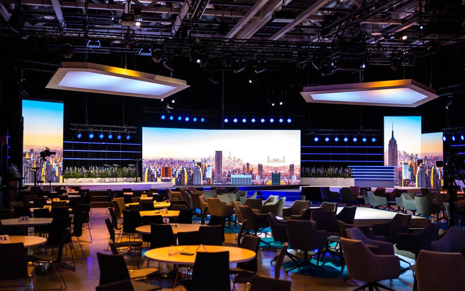 Large conference stage with three LED screen surfaces and Edgetron fixtures, Sandvik TMM 2022 Strawberry Fields