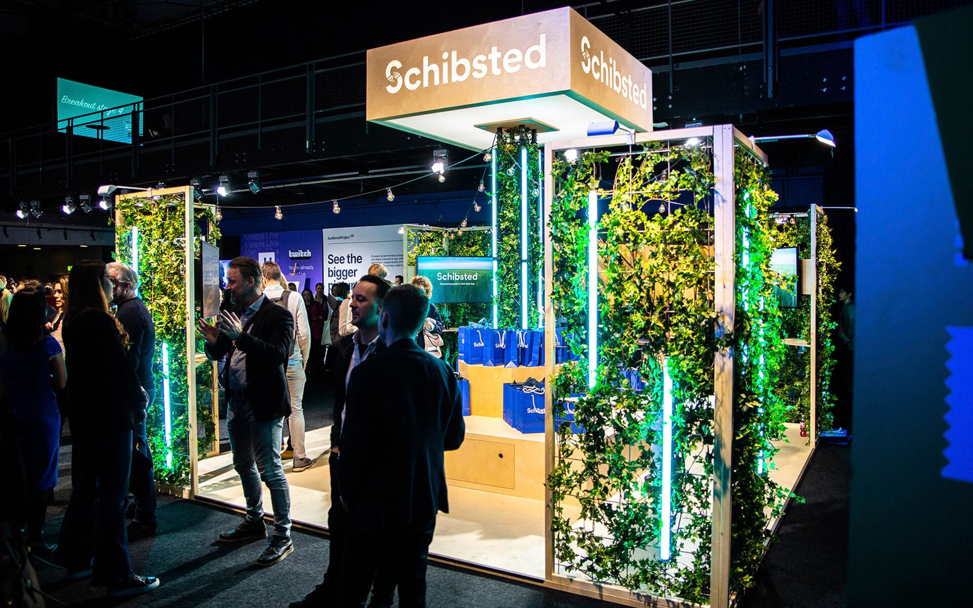 Seating unit with truss tower and light box in Schibsted's exhibition stand, NextM Annexet