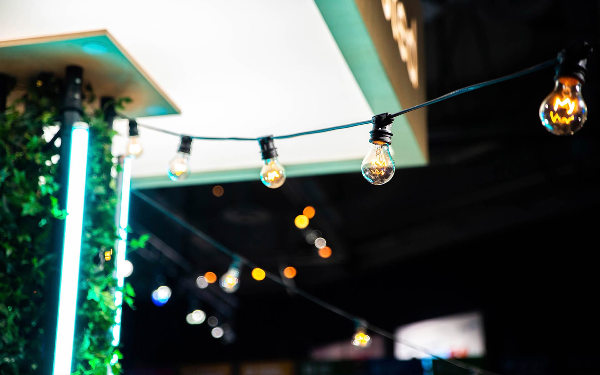 Festoon lights from truss to trellises as ambient lighting, Schibsted stand NextM