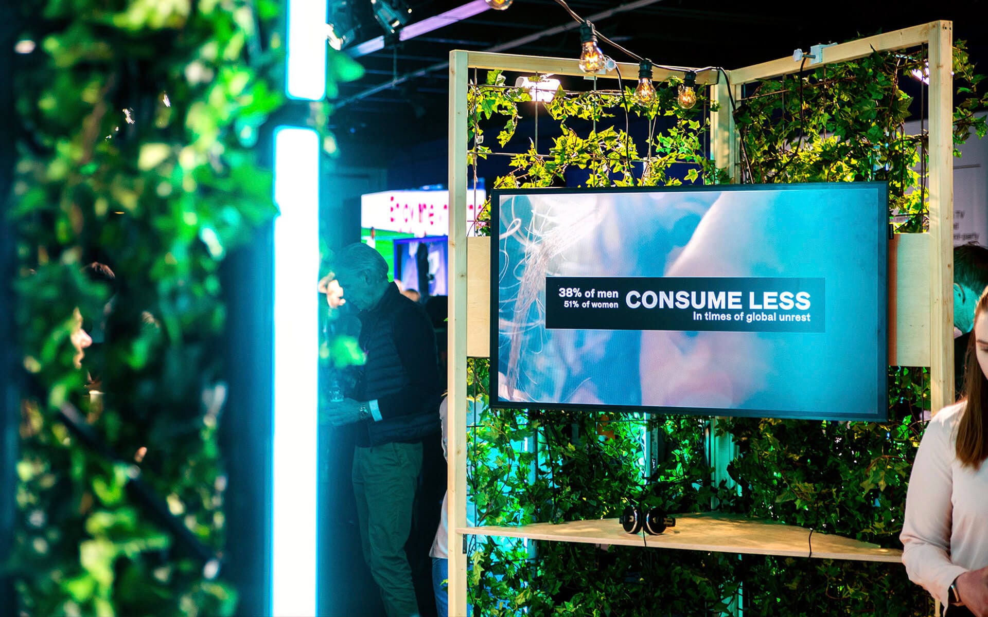 TV screen on inside of trellis showing presentation material, Schibsted stand NextM