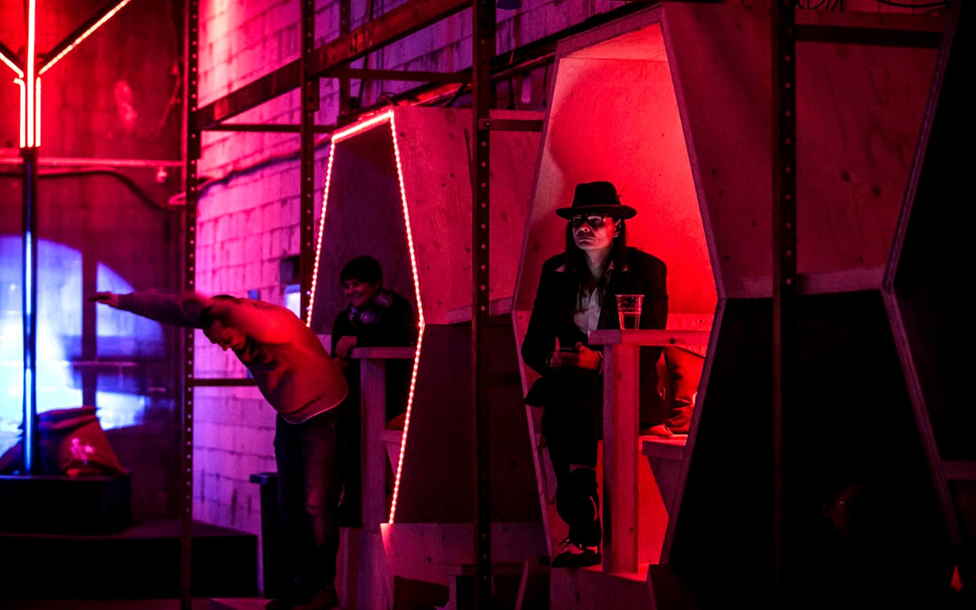 Festival goers moving among illuminated hexagons, Estrella activation Nobelberget 2016